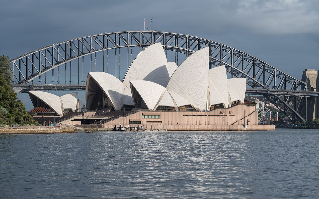 The white sails of Sydney Opera House beside Sydney Harbour.