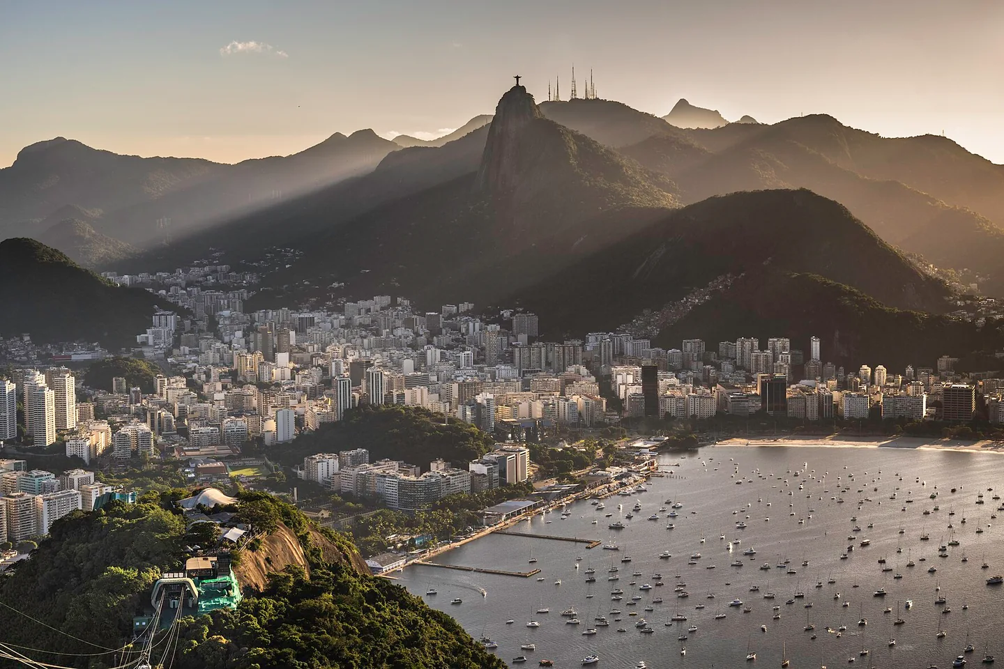 Rio de Janeiro’s bay and mountainous skyline in the soft light of sunset, seen from Sugarloaf Mountain.