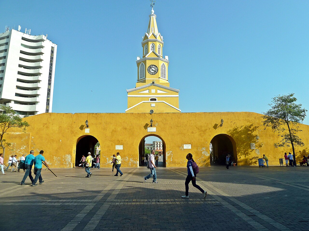 Cartagena’s yellow Clock Tower and its historic city gateway.